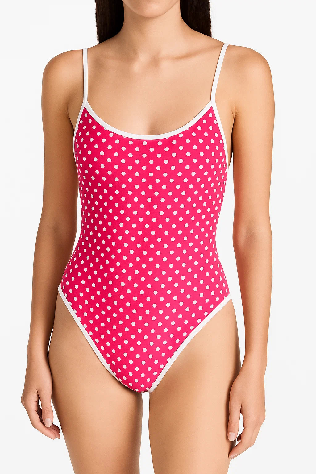 Pink polka dot swimsuit worn by a model on a white background